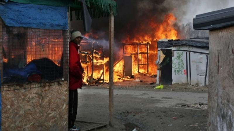 The fire broke out following a fight between rival groups of migrants. (Photo: AP) The fire broke out following a fight between rival groups of migrants. (Photo: AP)