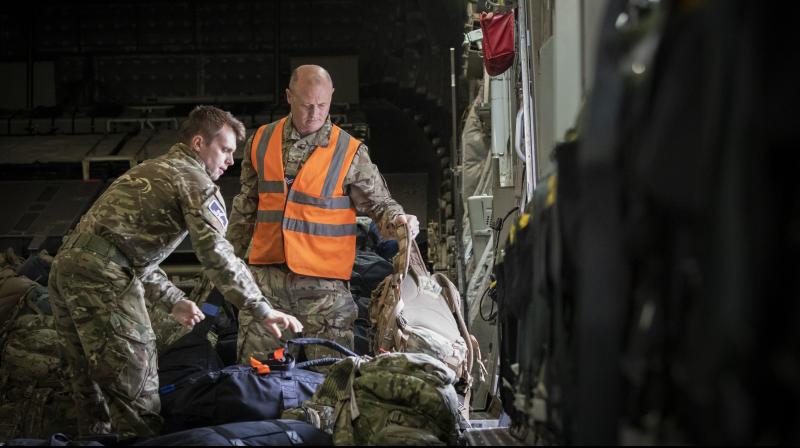 Mmilitary personnel work onboard the C-17 aircraft after landing at RAF Brize Norton, in Oxfordshire, England, Sunday, Aug. 29, 2021. (Photo: AP)