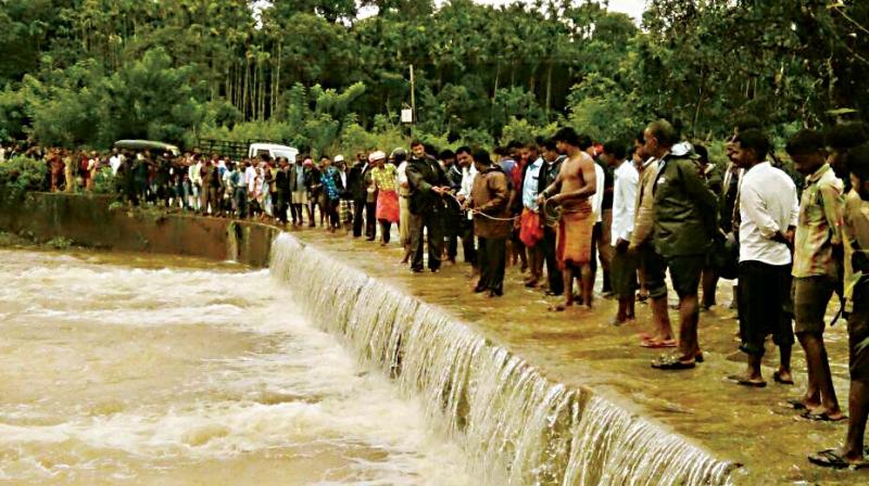 Rescuers search for missing Ashok who is feared to have been washed away in a stream in Koppa in Chikkamagaluru district on Wednesday. Rescuers search for missing Ashok who is feared to have been washed away in a stream in Koppa in Chikkamagaluru district on Wednesday.