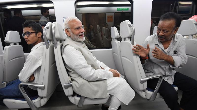 Prime Minister Narendra Modi on Thursday took a 14-minute ride in the Airport Express Metro from Dhaula Kuan to Dwarka to attend an event. (Photo: Twitter | @narendramodi) Prime Minister Narendra Modi on Thursday took a 14-minute ride in the Airport Express Metro from Dhaula Kuan to Dwarka to attend an event. (Photo: Twitter | @narendramodi)