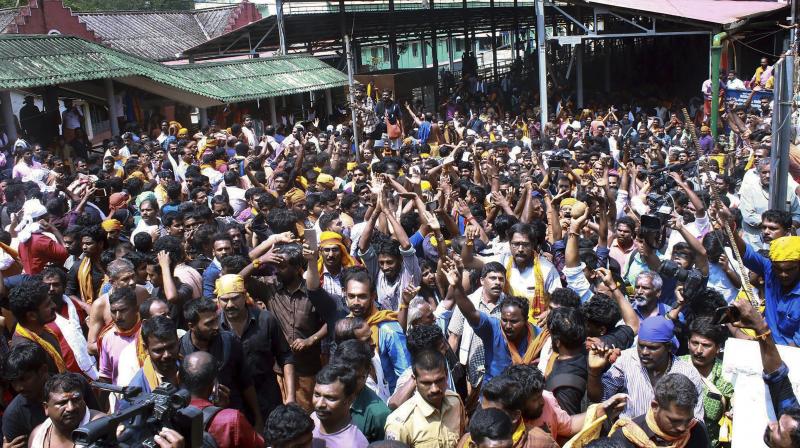 Devotees protest as several female devotee arrive to offer prayers at Sabarimala temple on Sunday. (Photo: PTI) Devotees protest as several female devotee arrive to offer prayers at Sabarimala temple on Sunday. (Photo: PTI)