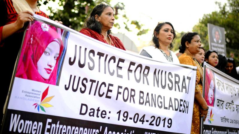 Protesters hold placards and gather to demand justice for Nusrat, who was burnt alive after she refused to drop sexual harassment charges against her Islamic school's principal, in Dhaka. (Photo: AP) Protesters hold placards and gather to demand justice for Nusrat, who was burnt alive after she refused to drop sexual harassment charges against her Islamic school's principal, in Dhaka. (Photo: AP)