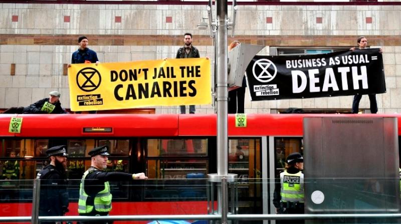 Banner-wielding climate change activists want the politicians to prioritise tackling environmental change to save the planet from irreparable damage. (Photo: AFP) Banner-wielding climate change activists want the politicians to prioritise tackling environmental change to save the planet from irreparable damage. (Photo: AFP)