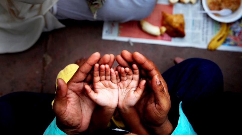 An Indian Muslim father holds the hands of his daughter in his palms and prays before breaking fast on the first day of holy month Ramadan at the Jama Mosque in New Delhi, India. (Photo: AP) An Indian Muslim father holds the hands of his daughter in his palms and prays before breaking fast on the first day of holy month Ramadan at the Jama Mosque in New Delhi, India. (Photo: AP)