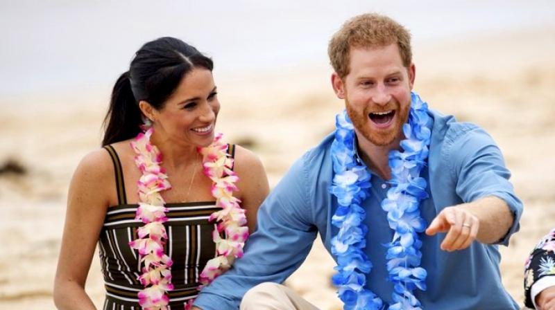Britain's Prince Harry and Meghan, Duchess of Sussex meet with a local surfing community group, known as OneWave, raising awareness for mental health and well-being at Bondi Beach in Sydney. (Photo: AP) Britain's Prince Harry and Meghan, Duchess of Sussex meet with a local surfing community group, known as OneWave, raising awareness for mental health and well-being at Bondi Beach in Sydney. (Photo: AP)