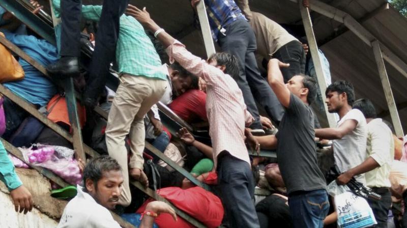 At least 22 people were killed and several injured in a rush hour stampede on a foot overbridge linking Elphinstone Road and Parel suburban stations in Mumbai on Friday morning. (Photo: PTI) At least 22 people were killed and several injured in a rush hour stampede on a foot overbridge linking Elphinstone Road and Parel suburban stations in Mumbai on Friday morning. (Photo: PTI)