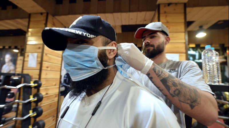 An athlete wears on March 9, 2020 a protective masks as he starts his training at a gym in the central Iraqi city of Najaf, where the first Iraqi case of novel coronavirus infection was confirmed. AFP Photo