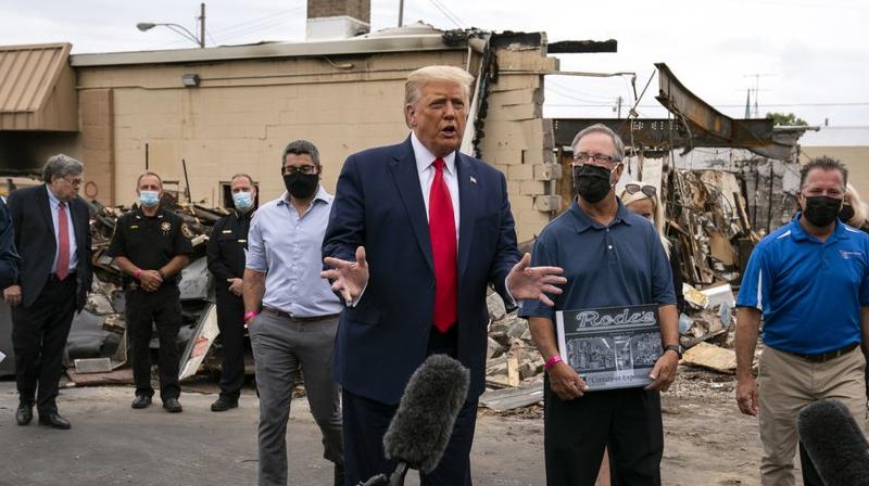 US President Donald Trump speaks as he tours an area Tuesday, Sept. 1, 2020, that was damaged during demonstrations after a police officer shot Jacob Blake in Kenosha. (AP) US President Donald Trump speaks as he tours an area Tuesday, Sept. 1, 2020, that was damaged during demonstrations after a police officer shot Jacob Blake in Kenosha. (AP)
