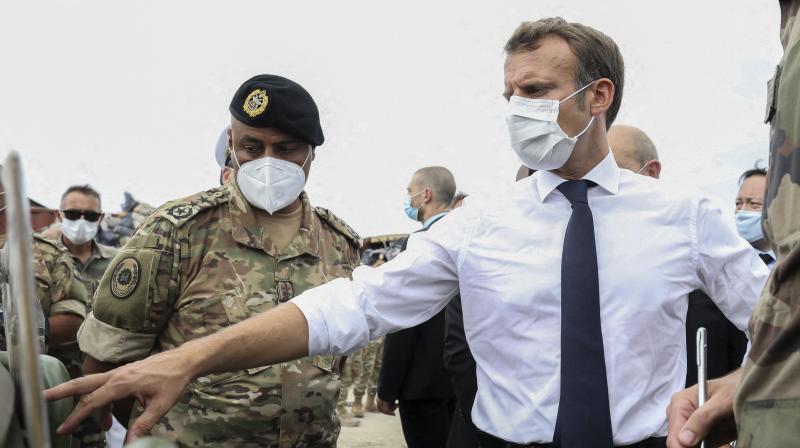 French President Emmanuel Macron gestures toward a board as he meets the military mobilized to help to rebuild the port of Beirut, Tuesday, Sept.1, 2020. President Emmanuel Macron issued a stern warning to Lebanons political class, urging them to commit to serious reforms within few months or risk punitive action including sanctions, if they fail to deliver. (AP)