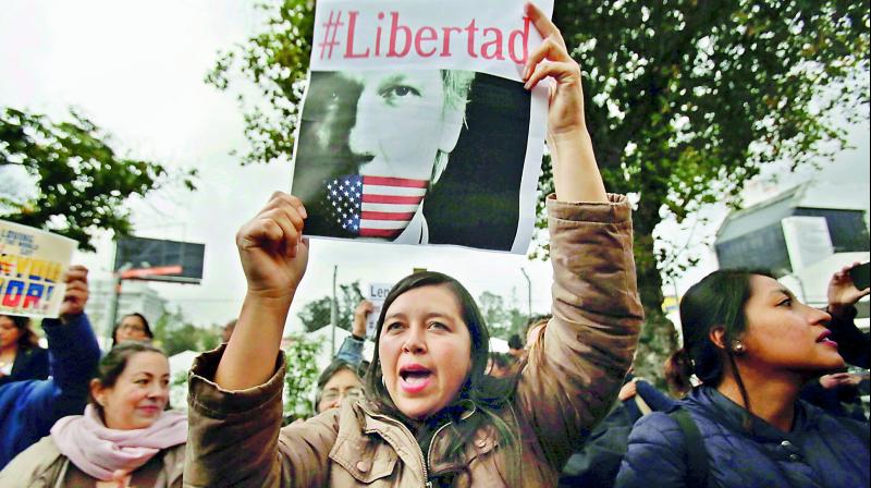 A woman holds up the Spanish hashtag #Freedom during a protest against the arrest of WikiLeaks founder Julian Assange, outside the Foreign Ministry in Quito, Ecuador. A woman holds up the Spanish hashtag #Freedom during a protest against the arrest of WikiLeaks founder Julian Assange, outside the Foreign Ministry in Quito, Ecuador.