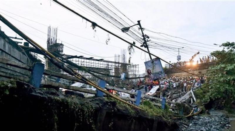 A section of Majerhat bridge collapsed in Kolkata on Tuesday. According to the police, a portion of the bridge collapsed this evening, claiming one life, trapping several people and crushing many vehicles. (Photo: PTI) A section of Majerhat bridge collapsed in Kolkata on Tuesday. According to the police, a portion of the bridge collapsed this evening, claiming one life, trapping several people and crushing many vehicles. (Photo: PTI)