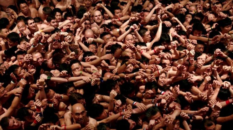 As holy water was splashed from above, camera flashes illuminated the sea of bodies like disco lights at a rave -- before all hell broke loose. (Photo: AFP) As holy water was splashed from above, camera flashes illuminated the sea of bodies like disco lights at a rave -- before all hell broke loose. (Photo: AFP)