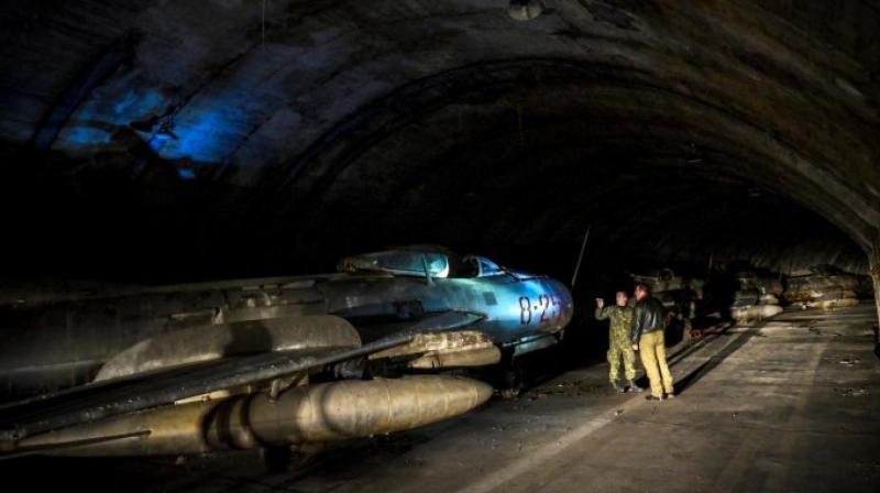 Albanian military personnel walk next to MIG-19 jet fighters inside the main tunnel of the Gjader Air Base built near the city of Lezhe. (Photo: AFP) Albanian military personnel walk next to MIG-19 jet fighters inside the main tunnel of the Gjader Air Base built near the city of Lezhe. (Photo: AFP)