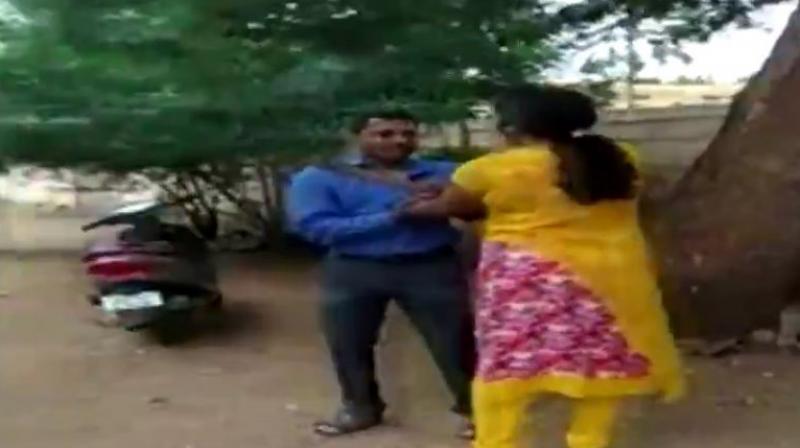 The woman resorted to kicking, punching and slapping the bank manager, holding him by his collar. (Photo: Screengrab | ANI) The woman resorted to kicking, punching and slapping the bank manager, holding him by his collar. (Photo: Screengrab | ANI)