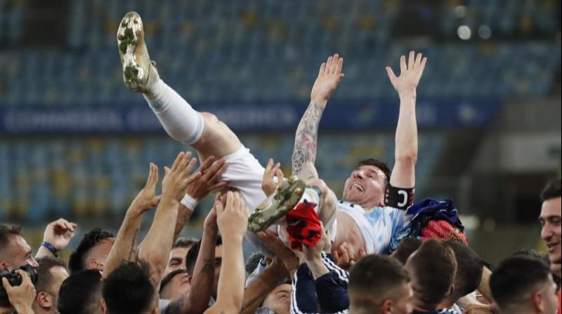 Teammates lift Argentinas Lionel Messi after beating Brazil 1-0 in the Copa America final soccer match at the Maracana stadium in Rio de Janeiro, Brazil. (Photo: AP)