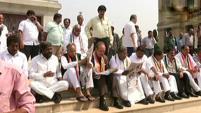 Congress lawmakers, accompanied by Ghulam Nabi Azad, Ashok Gehlot and former Karnataka CM Siddaramaiah were protesting against B S Yeddyurappa's swearing in as Chief Minister of Karnataka. (Photo: ANI | Twitter) Congress lawmakers, accompanied by Ghulam Nabi Azad, Ashok Gehlot and former Karnataka CM Siddaramaiah were protesting against B S Yeddyurappa's swearing in as Chief Minister of Karnataka. (Photo: ANI | Twitter)