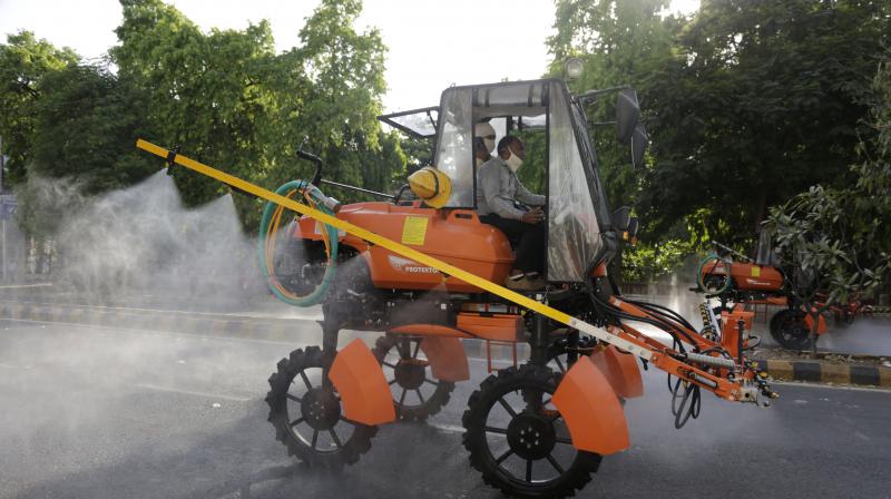 Fire brigade personnel spray disinfectants as precautionary measures against the Covid-19 pandemic. (AP)