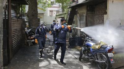 Fire service personnel disinfect a residential area during lockdown to prevent the spread of new coronavirus. (AP)