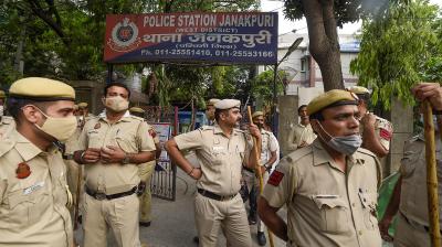 Police personnel stand guard as BJP workers protest against arrest of party spokesperson Tajinder Pal Singh Bagga, at Janakpuri police station in New Delhi, Friday, May 6, 2022. (PTI Photo)