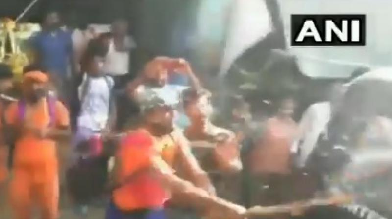Since the police could not contain the situation they can be seen reversing the car in the footage. (Photo: ANI/Twitter) Since the police could not contain the situation they can be seen reversing the car in the footage. (Photo: ANI/Twitter)
