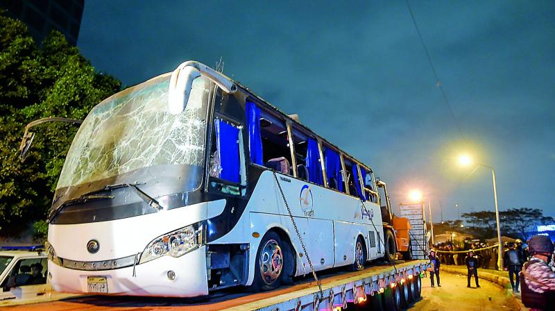 A tourist bus which was attacked being towed away in Giza province on Friday. Three Vietnamese holidaymakers and an Egyptian tour guide were killed when a roadside bomb blast hit their bus as it travelled close to the Giza pyramids outside Cairo. (AFP) A tourist bus which was attacked being towed away in Giza province on Friday. Three Vietnamese holidaymakers and an Egyptian tour guide were killed when a roadside bomb blast hit their bus as it travelled close to the Giza pyramids outside Cairo. (AFP)