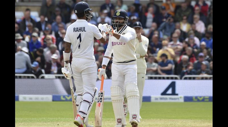 Indias Ravindra Jadeja (right) bumps fists with batting partner K. L. Rahul during the third day of first cricket Test at Trent Bridge in Nottingham on Friday.	 AP