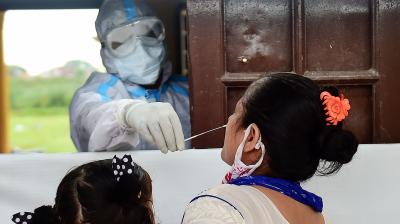 Health workers collect swab samples to conduct tests for Covid-19
