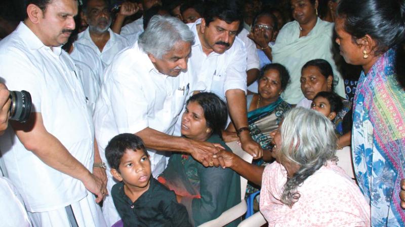 Former chief minister Ommen Chandy listens to women at the relief camp during the UDF team’s visit at Poonthura on Monday. MLAs K. Muraleedharan and V. S. Sivakumar are also seen. (Photo: DC) Former chief minister Ommen Chandy listens to women at the relief camp during the UDF team’s visit at Poonthura on Monday. MLAs K. Muraleedharan and V. S. Sivakumar are also seen. (Photo: DC)