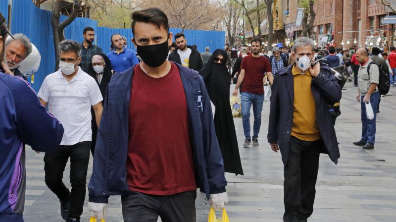 Iranians, some wearing protective masks,walk outside the capital Tehran's grand bazaar, during the Covid-19 coronavirus pandemic crises. AFP Photo Iranians, some wearing protective masks,walk outside the capital Tehran's grand bazaar, during the Covid-19 coronavirus pandemic crises. AFP Photo