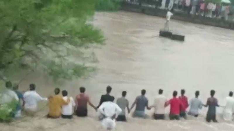 One person was rescued by the locals while search operation for another person is underway. (Photo: ANI) One person was rescued by the locals while search operation for another person is underway. (Photo: ANI)