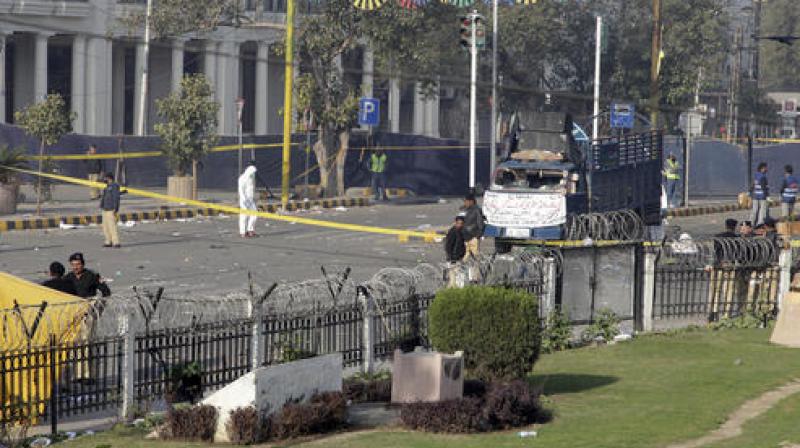 Pakistani investigators work at the site of a deadly bomb blast on Monday, in Lahore, Pakistan. (Photo: AP) Pakistani investigators work at the site of a deadly bomb blast on Monday, in Lahore, Pakistan. (Photo: AP)
