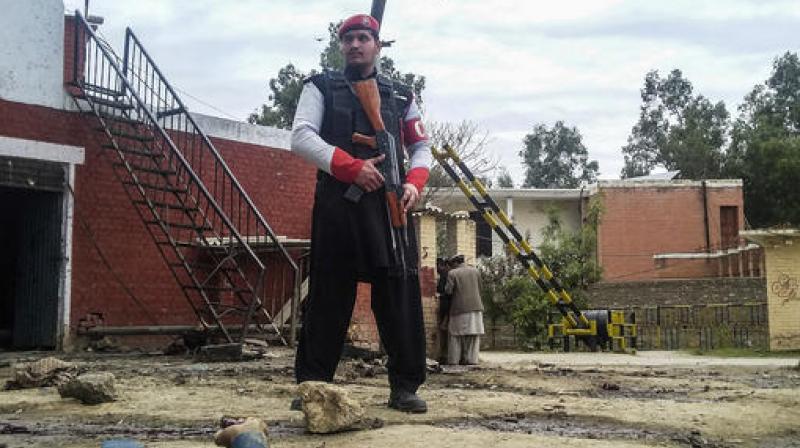 A Pakistani security officer stands alert at the site of a bombing in Ghalanai in the Pakistan's tribal region of Mohmand. (Photo: AP) A Pakistani security officer stands alert at the site of a bombing in Ghalanai in the Pakistan's tribal region of Mohmand. (Photo: AP)