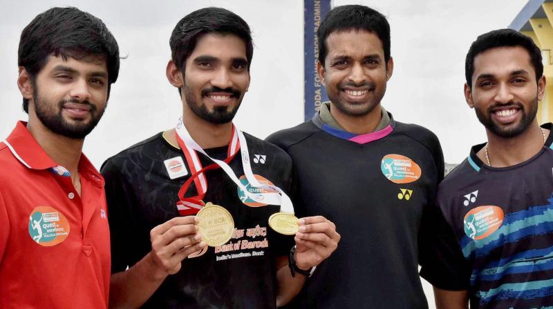 Shuttlers Kidambi Srikanth, B Sai Praneeth, H S Prannoy along with Chief National Coach P Gopichand were today felicitated by Telangana Governor ESL Narasimhan here.(Photo: AP) Shuttlers Kidambi Srikanth, B Sai Praneeth, H S Prannoy along with Chief National Coach P Gopichand were today felicitated by Telangana Governor ESL Narasimhan here.(Photo: AP)