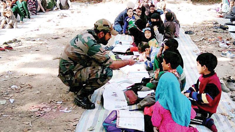 A jawan provides free coaching to students at Awantipora in south Kashmir (Photo: PTI) A jawan provides free coaching to students at Awantipora in south Kashmir (Photo: PTI)