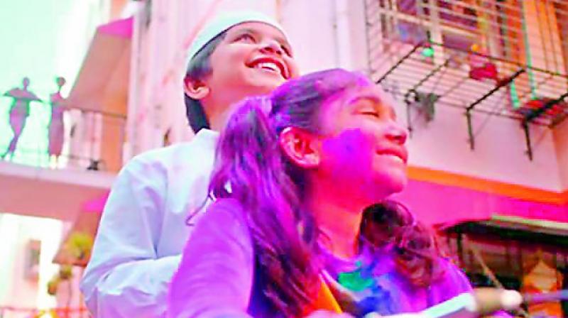 A screenshot of the Surf Excel’s one minute-long commercial, which features a young Hindu girl, dressed in a white t-shirt, choosing to get stained in Holi colours in order to protect her young Muslim friend who has to go to the nearby mosque to pray. A screenshot of the Surf Excel’s one minute-long commercial, which features a young Hindu girl, dressed in a white t-shirt, choosing to get stained in Holi colours in order to protect her young Muslim friend who has to go to the nearby mosque to pray.
