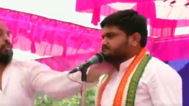 As soon as Hardik Patel started his speech at Baldana village under Wadhwan taluka, a man suddenly came on the stage and slapped him. (Photo: Screengrab) As soon as Hardik Patel started his speech at Baldana village under Wadhwan taluka, a man suddenly came on the stage and slapped him. (Photo: Screengrab)