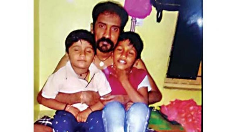 Chandrashekhar with his disabled son, Lokeshwar (left). The garment worker smothered his son to death before hanging himself (Photo: DC) Chandrashekhar with his disabled son, Lokeshwar (left). The garment worker smothered his son to death before hanging himself (Photo: DC)