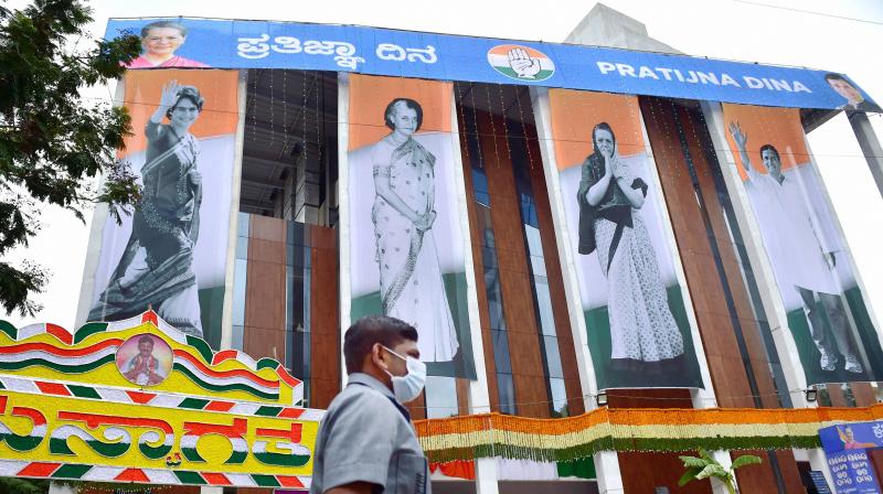 Posters of senior Congress leaders Sonia Gandhi, Indira Gandhi, Rahul Gandhi and Priyanka Gandhi Vadra on the newly built KPCC office during oath taking ceremony Pratigna Dina of KPCC President, in Bengaluru. PTI Photo