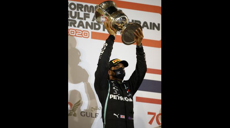 Mercedes driver Lewis Hamilton of Britain lifts the trophy on the podium after winning the Formula One race in Bahrain International Circuit in Sakhir, Bahrain, on Sunday. AP Mercedes driver Lewis Hamilton of Britain lifts the trophy on the podium after winning the Formula One race in Bahrain International Circuit in Sakhir, Bahrain, on Sunday. AP