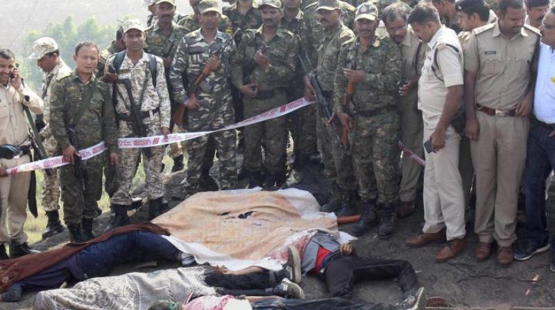 Police investigate the encounter site at the hillocks of Acharpura village after the STF killed 8 Students of Islamic Movement of India (SIMI). (Photo: PTI) Police investigate the encounter site at the hillocks of Acharpura village after the STF killed 8 Students of Islamic Movement of India (SIMI). (Photo: PTI)