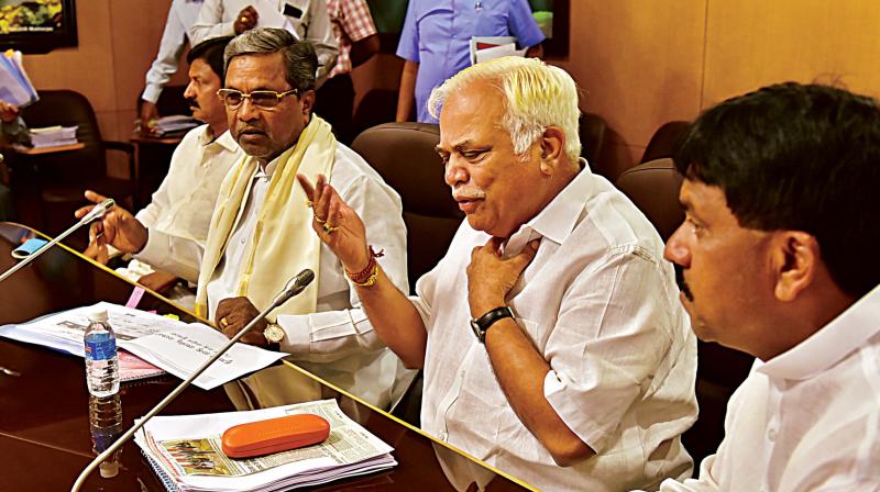 Chief Minister Siddaramaiah and Major Industries Minister R.V. Deshpande at an Industries department review meeting at Vidhana Soudha in Bengaluru on Wednesday. Chief Minister Siddaramaiah and Major Industries Minister R.V. Deshpande at an Industries department review meeting at Vidhana Soudha in Bengaluru on Wednesday.