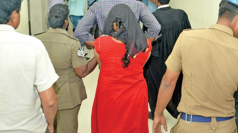 The woman being taken into custody for her controversial post in Facebook (Photo: DC) The woman being taken into custody for her controversial post in Facebook (Photo: DC)