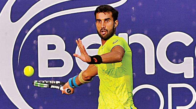 Yuki Bhambri plays a return in his quarter-final victory over Prajnesh Gunneswaran at the KSLTA courts in Bengaluru on Thursday (Photo: SHASHIDHAR B.) Yuki Bhambri plays a return in his quarter-final victory over Prajnesh Gunneswaran at the KSLTA courts in Bengaluru on Thursday (Photo: SHASHIDHAR B.)