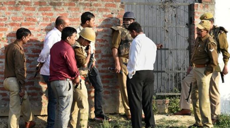 Police personnel during their operation against a suspected terrorist holed up inside a building in the Thakurganj area of Lucknow on Tuesday evening. (Photo: PTI) Police personnel during their operation against a suspected terrorist holed up inside a building in the Thakurganj area of Lucknow on Tuesday evening. (Photo: PTI)