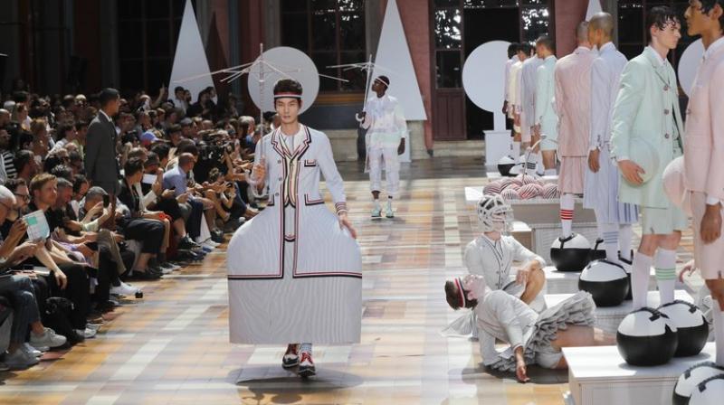 The incredible fabric fountain led the gaze of guests inside the Ecole des Beaux-Arts on to a line of frozen human mannequins decked in dramatic A-line doll costumes. (Photo: AP) The incredible fabric fountain led the gaze of guests inside the Ecole des Beaux-Arts on to a line of frozen human mannequins decked in dramatic A-line doll costumes. (Photo: AP)