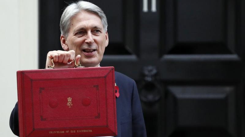 Britain's Chancellor of the Exchequer Philip Hammond holds up the traditional red dispatch box. Britain's Chancellor of the Exchequer Philip Hammond holds up the traditional red dispatch box.