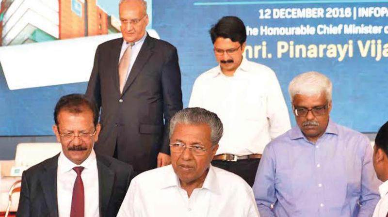 Chief Minister Pinarayi Vijayan with IBS executive chairman V.K. Mathews, IT secretary M. Sivasankar and Infopark CEO Hrishikesh Nair after inaugurating the company's Kochi campus project on Monday. (Photo: File/DC) Chief Minister Pinarayi Vijayan with IBS executive chairman V.K. Mathews, IT secretary M. Sivasankar and Infopark CEO Hrishikesh Nair after inaugurating the company's Kochi campus project on Monday. (Photo: File/DC)