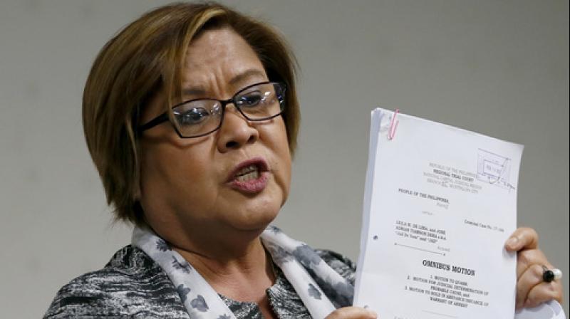 Philippine Sen. Leila de Lima shows documents on her petition to dismiss charges filed against her. (Photo: AP) Philippine Sen. Leila de Lima shows documents on her petition to dismiss charges filed against her. (Photo: AP)