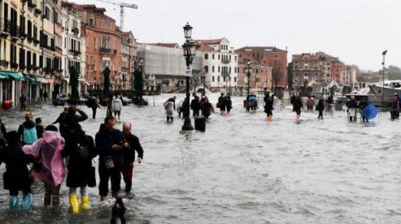 People walk in the flooded street during a high-water alert in Venice. (Photo: AFP) People walk in the flooded street during a high-water alert in Venice. (Photo: AFP)
