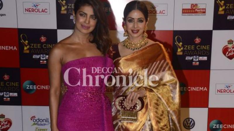 Priyanka Chopra and Sridevi pose at an awards show. Priyanka Chopra and Sridevi pose at an awards show.